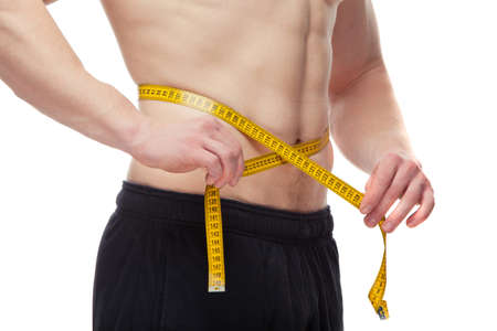Athletic young man measuring his body beltの写真素材