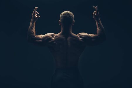 Back of a muscular man naked, studio shot.の写真素材