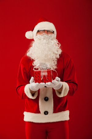Photo of kind Santa Claus giving xmas presentの写真素材