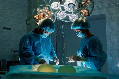 Surgeons team working with Monitoring of patient in surgical operating roomの写真素材