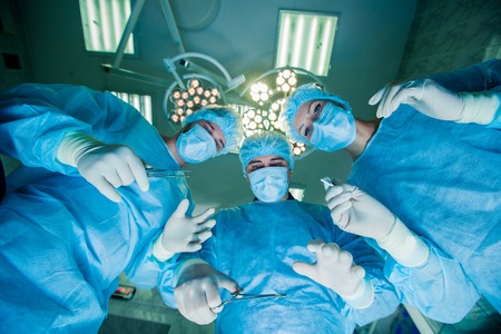 Surgeons standing above of the patient before surgery.の写真素材