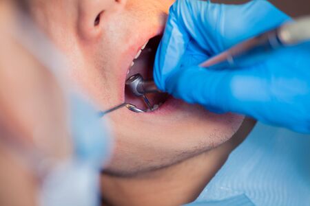Dentist treatment a patient's teeth in the dentist