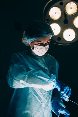 Surgeons working with Monitoring of patient in surgical operating room. breast augmentation.の写真素材