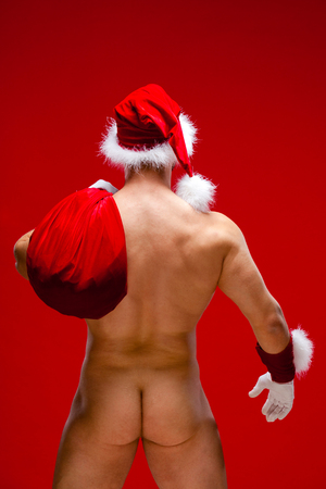 Portrait of a handsome young man in Santa Claus hat. Christmas.の写真素材