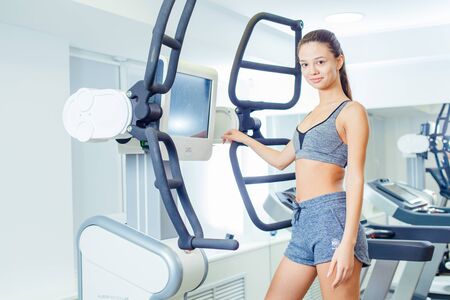 VOLGOGRAD, RUSSIA - DECEMBER 7, 2017: Occupation in the fitness club v club on the simulator of the...