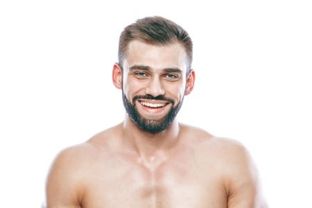 He stroked and touched his beard. A beautiful beard. Beautiful sporty guy male power. Fitness muscled in blue shorts. on isolated white background.の写真素材