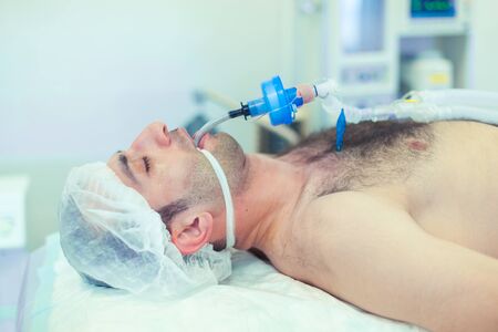 Anesthesiologist performing tracheal intubation in operation room. Preparation for surgery.