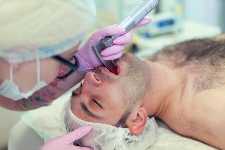 Anesthesiologist performing tracheal intubation in operation room. Preparation for surgery. Rhinoplastyの写真素材