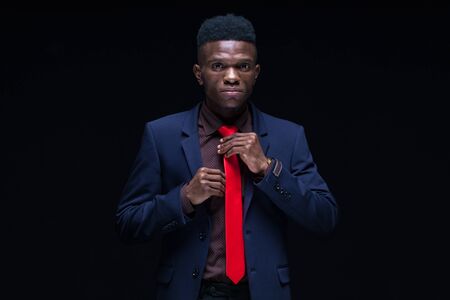 Portrait successful smiling cheerful african american businessman executive stylish company leader. Isolated on black background.の写真素材