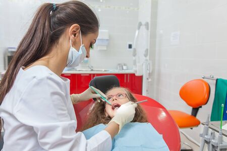A child with a dentist in a dental office.の写真素材