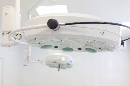 Hospital. Surgeon operates in the operating room. Surgical lamp and medical devices in the operating room. Latest technology in medicineの写真素材