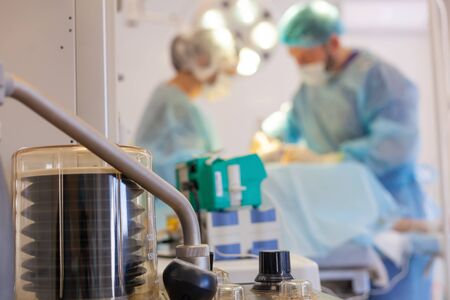 Hospital. Surgeon operates in the operating room. Lung ventilator and medical devices in the...