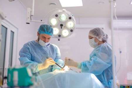 Hospital. Surgeon operates in the operating room. Doctors do everything possible to treat the patient after an accidentの写真素材