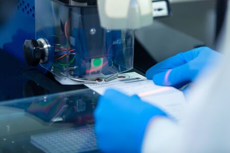 DNA laboratory. The expert puts the human DNA into the database using advanced laboratory...