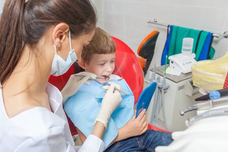 A child with a dentist in a dental office.の写真素材