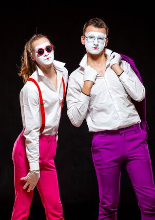 Portrait of male mime artists, isolated on black background. Two man are posing for camera. Symbol of friendship, lovers, tolerance, LGBTの写真素材