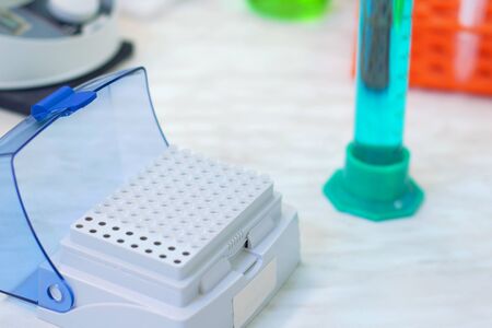 Laboratory worker puts samples into a tray making analysis for immunity viruses in a medical laboratoryの写真素材