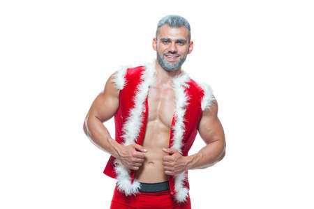 Sexy Santa Claus . Young muscular man wearing Santa Claus hat demonstrate his muscles. Isolated on...