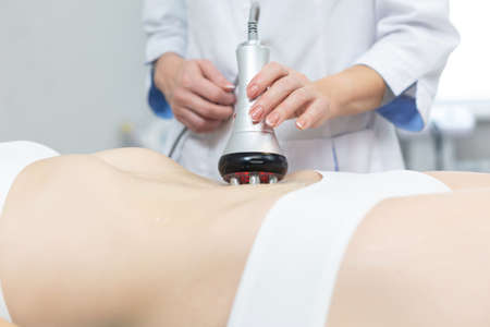 Close up shot of a relaxed woman getting RF lifting endospheres therapy massage at spa center. Due to the deep heating of muscle tissues, a fast and stable lifting effect is achieved, the process of producing your own collagen is started.の写真素材