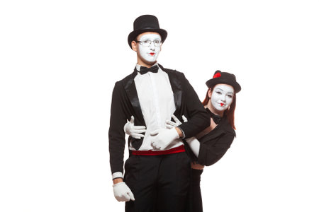 Portrait of two mime artists performing, isolated on white background. Symbol of meeting, unexpected appearance, friendship, embarrassmentの写真素材