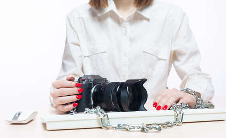 Copyright. The camera is chained to the photographers hand. The concept of protecting the...