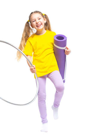 Little cute girl with  hoop and gym mat. Isolated on white background.の写真素材