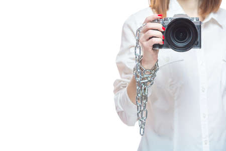 Copyright. The camera is chained to the photographers hand. The concept of protecting the photographer from theft of his photos. Isolated on white background.の写真素材