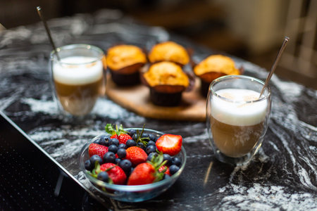 Close-up. Breakfast for two. Coffee latte with strawberry muffins.の写真素材