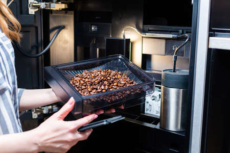 Maintenance of modern coffee machines. Loading coffee beans.の写真素材