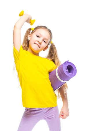 Little cute happy girl with dumbbell and gymnastic mat. Isolated on white background.の写真素材
