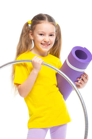 Little cute girl with hula hoop and gym mat. Isolated on white background.の写真素材