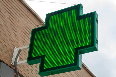 Green cross sign on the wall in the city. Green cross signの写真素材
