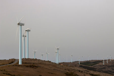<p>windmills, on the crest of a mountain, producers of electricity, clean and renewable, on a cloudy...
