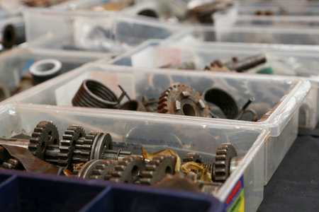 Various motorcycle engine parts, made of metal, steel, or iron. You can see engine blocks, cylinders, sprockets, headlights, speedometers, etc.の写真素材