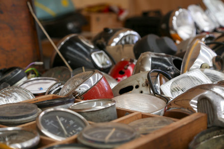 Various motorcycle parts, made of metal, steel, or iron. You can see engine blocks, cylinders, sprockets, headlights, speedometers, etc.の写真素材