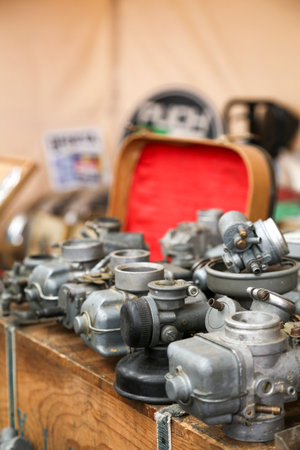 Various motorcycle engine parts, made of metal, steel, or iron. You can see engine blocks, cylinders, sprockets, headlights, speedometers, etc.の写真素材