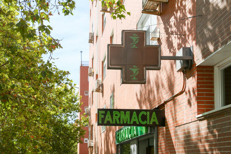 Pharmacy sign at a store selling medical products and drugs in the capital of Spain.の写真素材