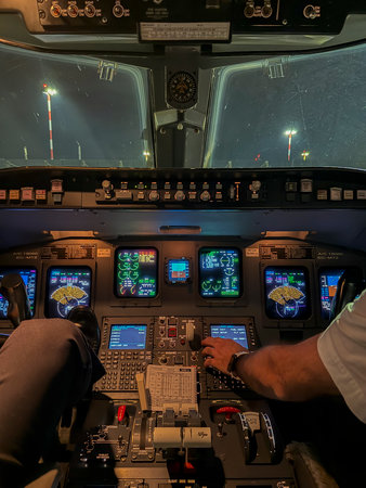 Cockpit of an aircraft with all its control lights illuminated on a winter night, flying from Madrid, Spain to Bologna, Italy.の写真素材