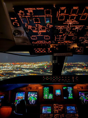 Cockpit of an aircraft with all its control lights illuminated on a winter night, flying from Madrid, Spain to Bologna, Italy.の写真素材