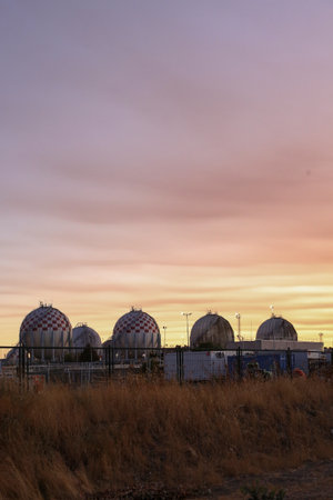 Spherical LPG fuel tanks in white and red colors at a facility near the city of Madridのeditorial素材