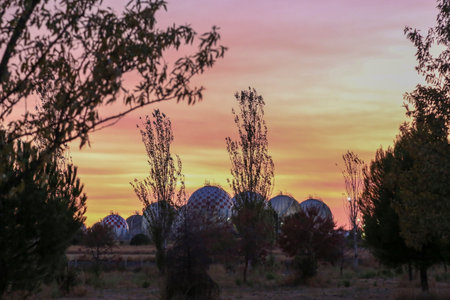 Spherical LPG fuel tanks in white and red colors at a facility near the city of Madridのeditorial素材