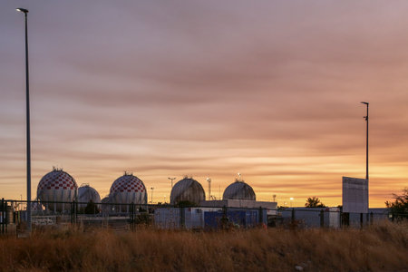 Spherical LPG fuel tanks in white and red colors at a facility near the city of Madridのeditorial素材