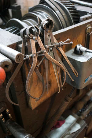 Closeup of a measuring special equipment like calipers, dividers & compass of old Lathe Machinery. Vintage Industrial Machinery in a old factory.の写真素材