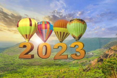 New year 2023 concept. Text 2022 hanging on the hot air baloon at sunset. New Year Startの写真素材