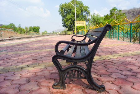 Railway sign board, seating bench at railway station platform of mountain village Kalakund near Mhow, Indore, Madhya Pradesh on a sunny summer day. Indian village.の写真素材
