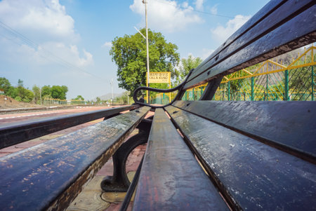 Railway sign board, seating bench at railway station platform of mountain village Kalakund near Mhow, Indore, Madhya Pradesh on a sunny summer day. Indian village.の写真素材