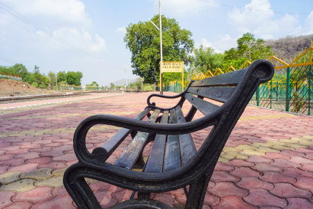 Railway sign board, seating bench at railway station platform of mountain village Kalakund near Mhow, Indore, Madhya Pradesh on a sunny summer day. Indian village.の写真素材