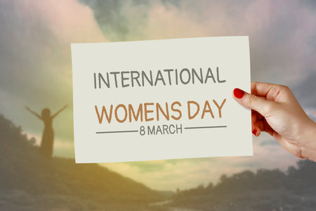 International women's day card on hand. Greeting for 8 March Happy Womens Day & 25 November International Day for the Elimination of Violence against Women.の写真素材