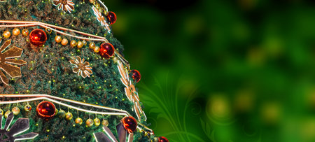 Closeup of a Christmas Tree on green bokeh background with floral swirl. Christmas Greeting. Copy Space.の写真素材