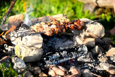 Marinated shashlik preparing on a barbecue grill over charcoal. Shashlik or Shish kebab popular in Eastern Europe. Shashlyk (skewered meat) was originally made of lamb.の写真素材